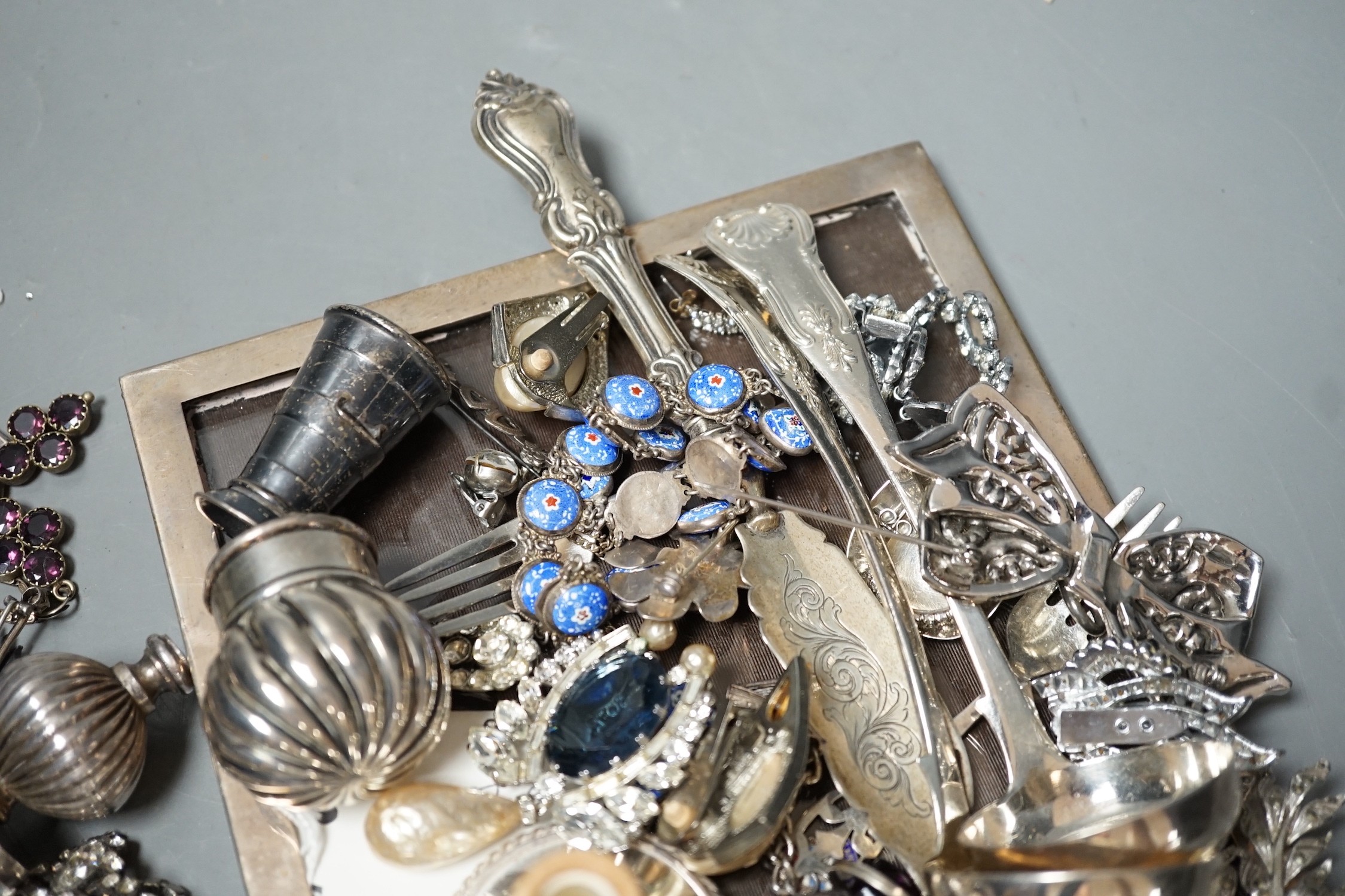 A George V silver mounted rectangular photograph frame, 21.6cm and other items including paste set costume jewellery, silver shell, silver churn condiment, enamelled necklace and earrings, etc.